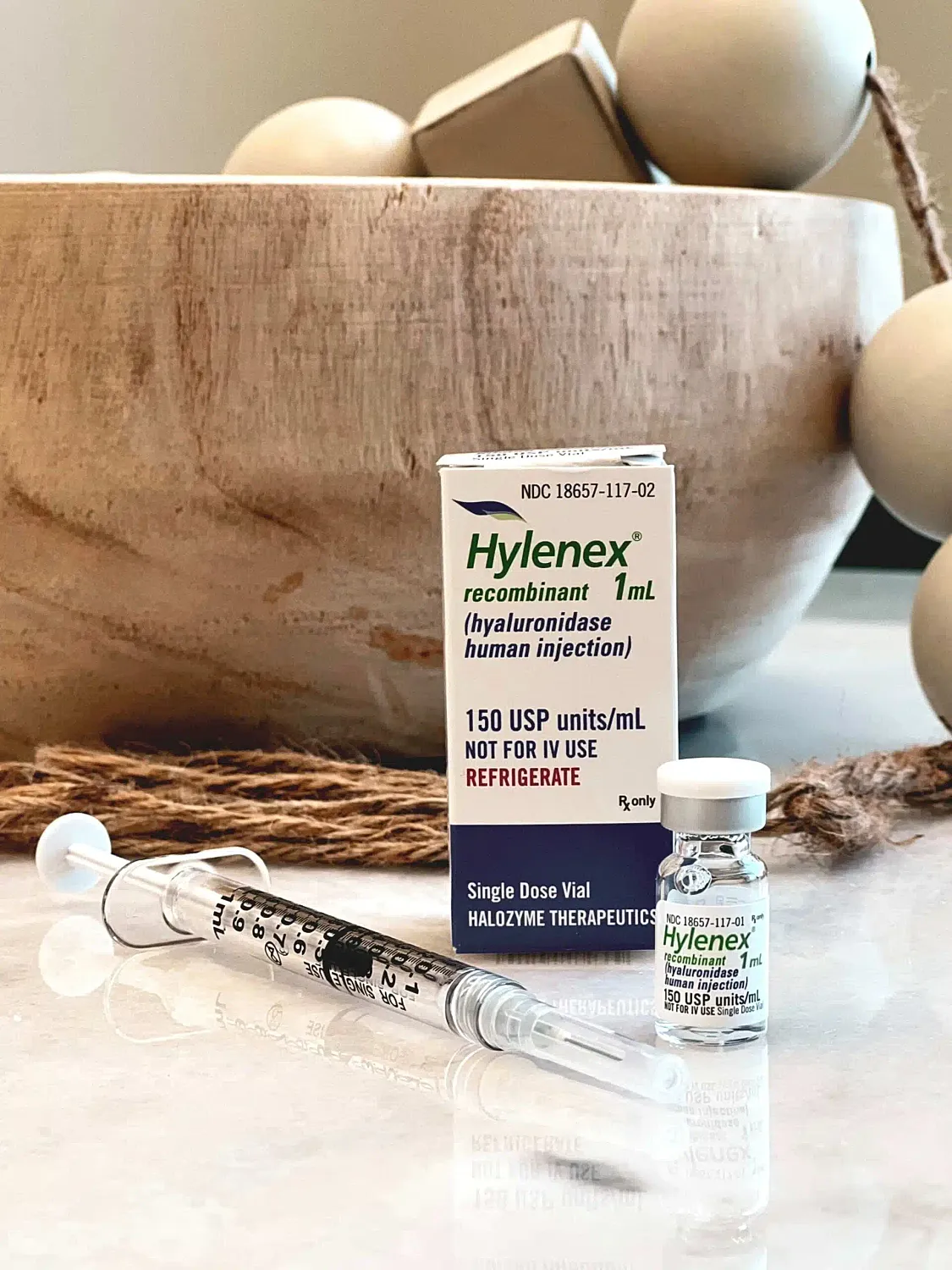 Hylenex medicine vial and syringe on countertop.