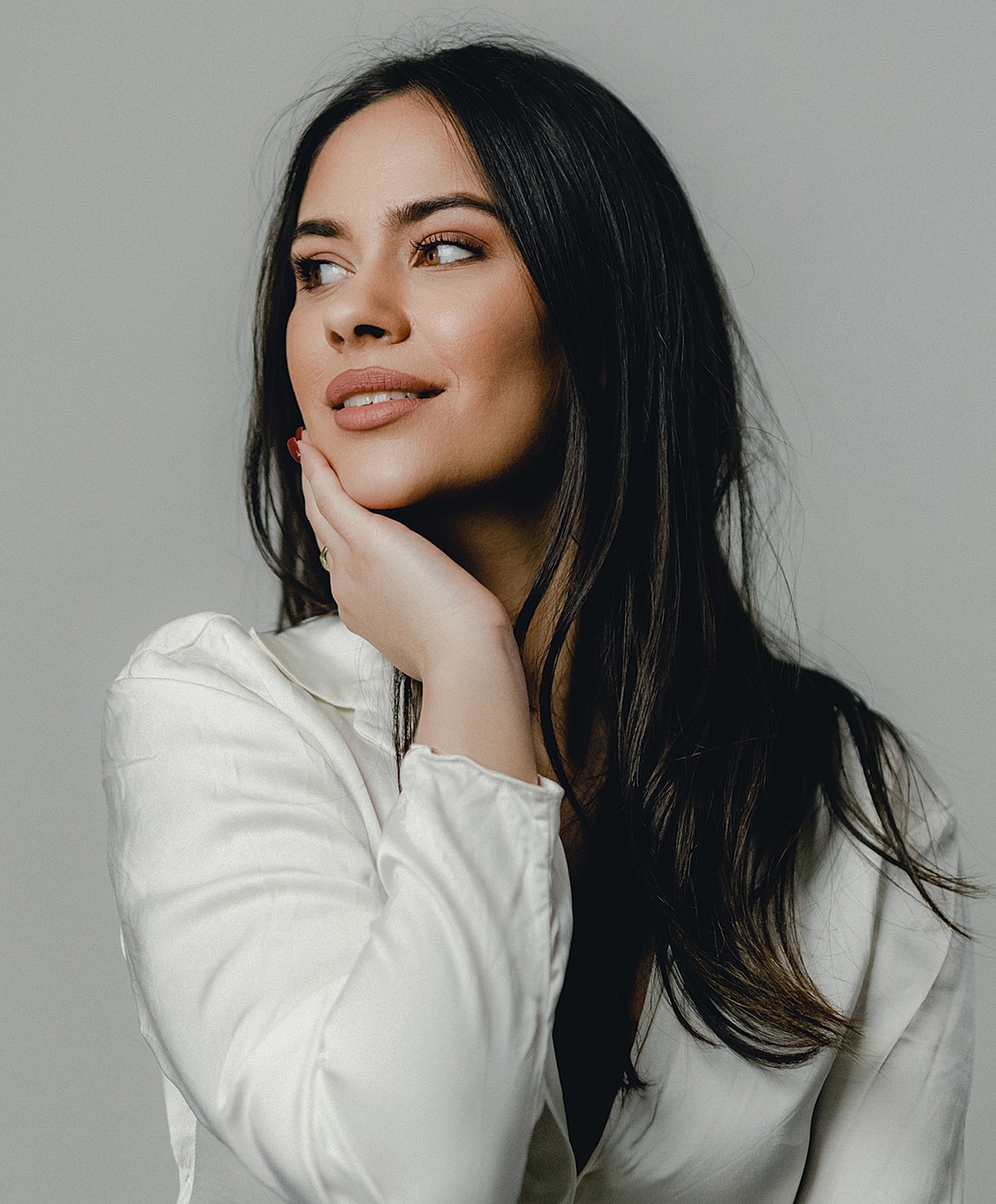 Woman with long hair in a white blouse.