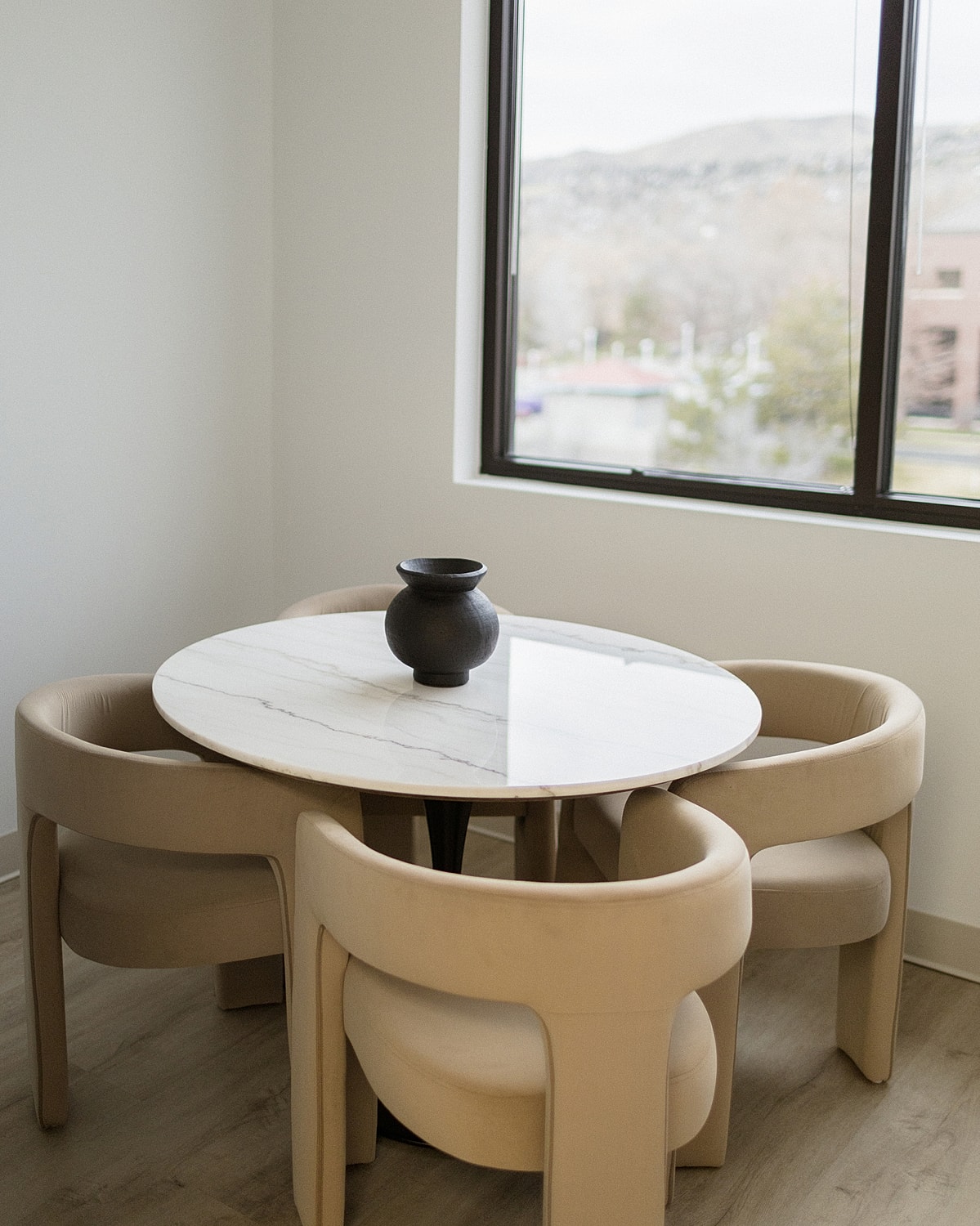 Modern waiting area with chair and artwork.