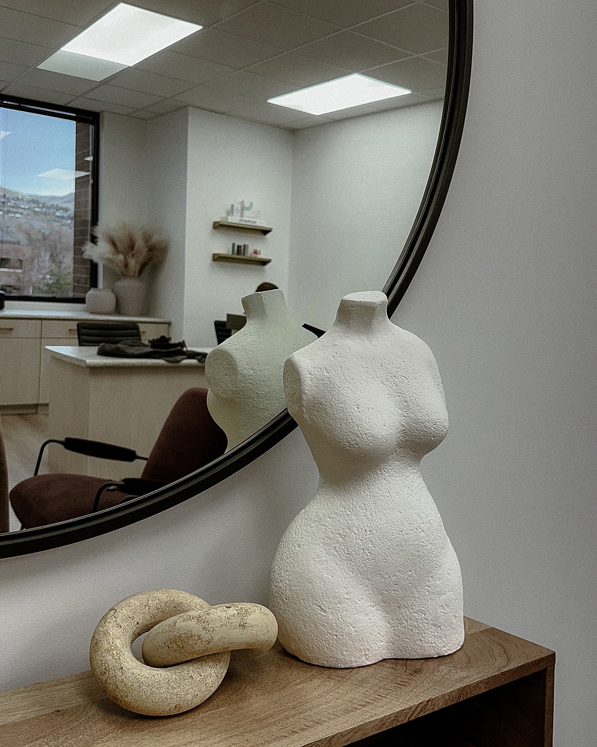 Ceramic vases with greenery by a window