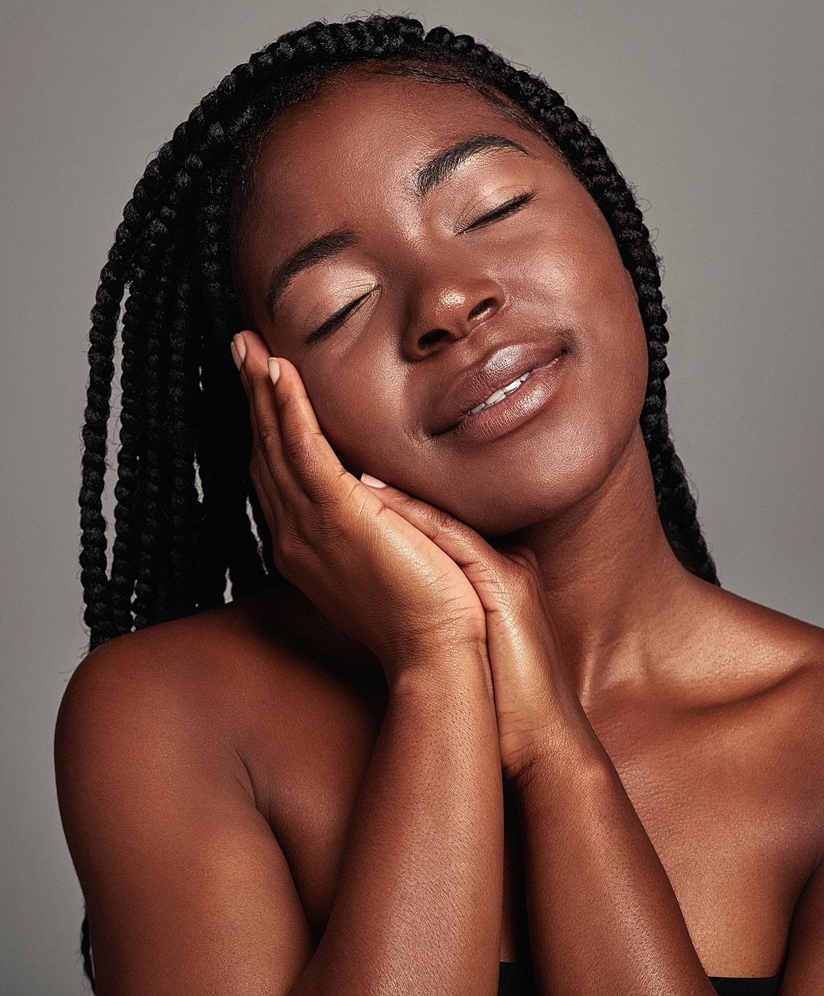 Woman with closed eyes, smiling softly.