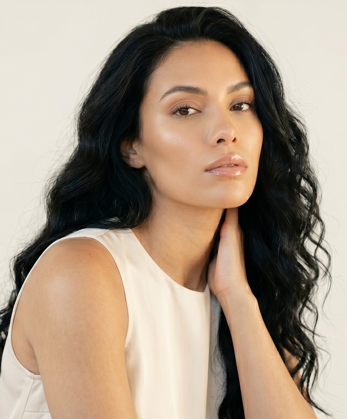 Woman with wavy hair in a gray top.