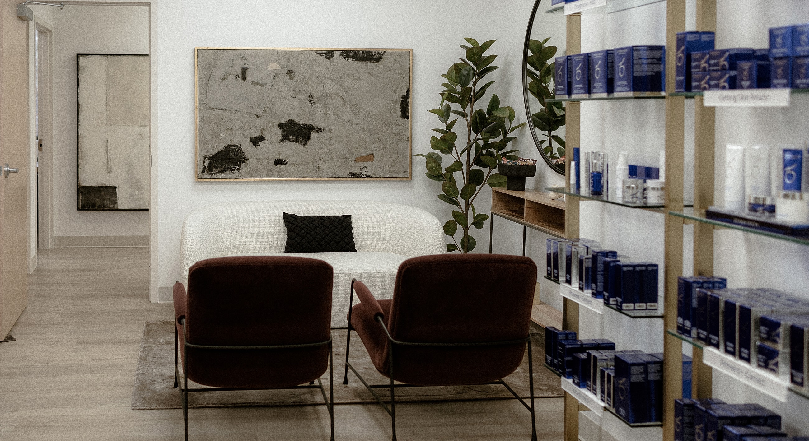 Modern waiting area with skincare products displayed.
