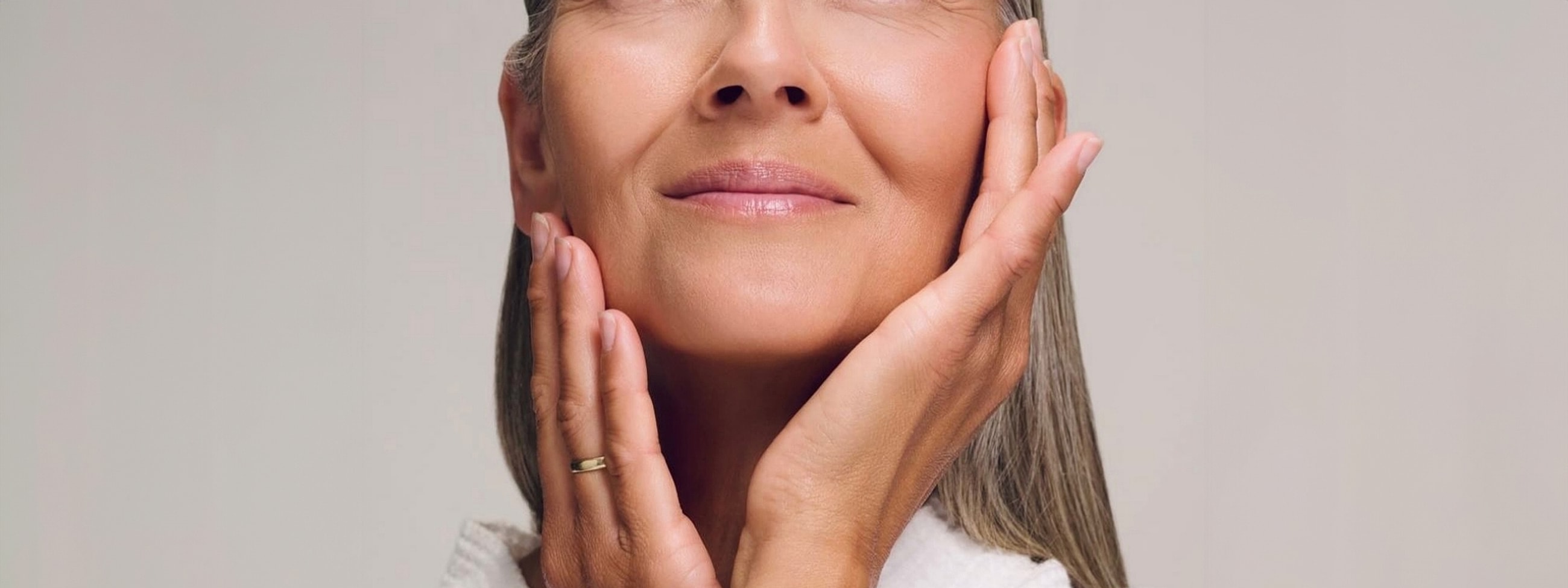 Woman gently touching her face, serene expression.