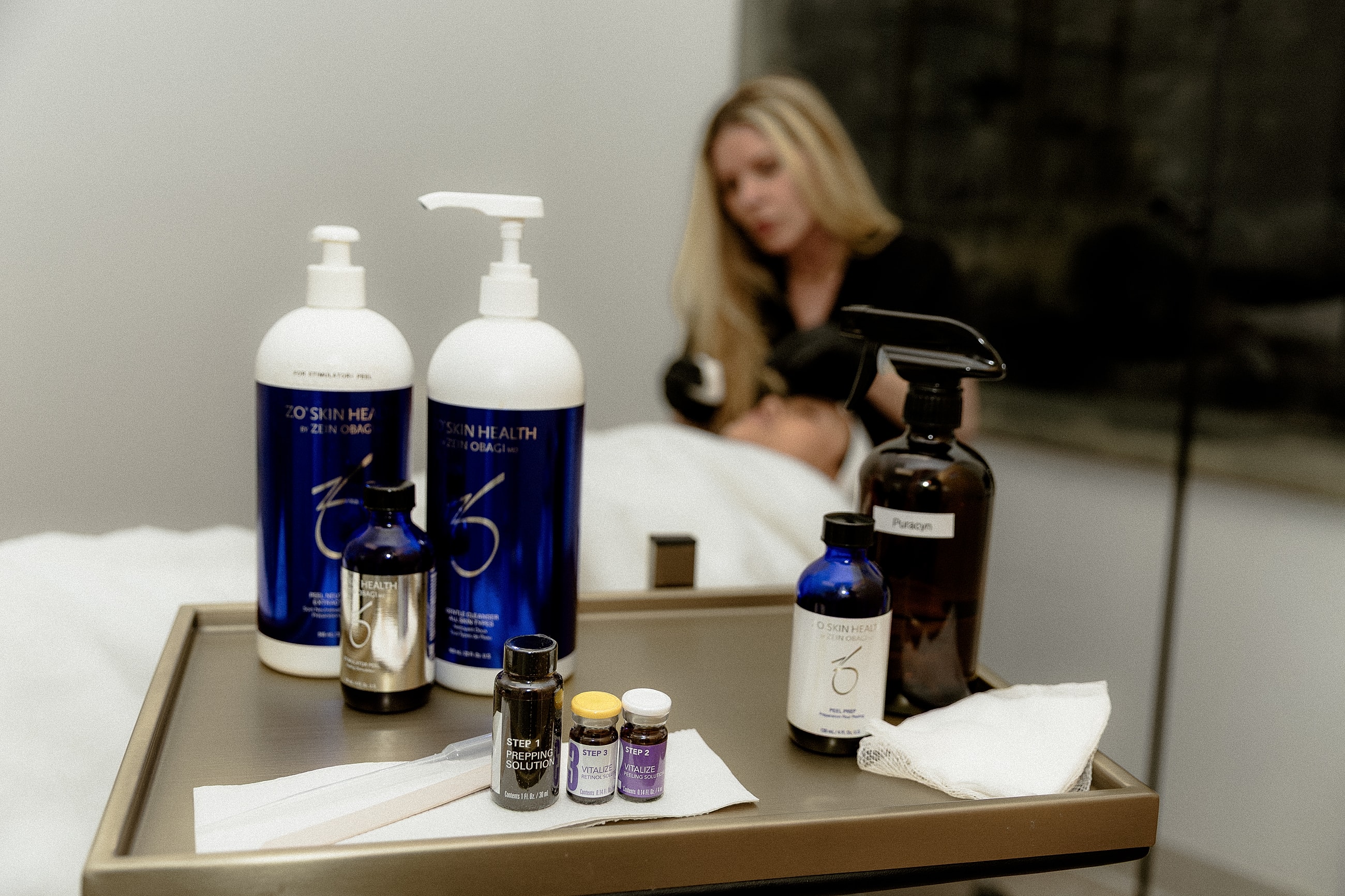 Skincare products on treatment cart in salon.