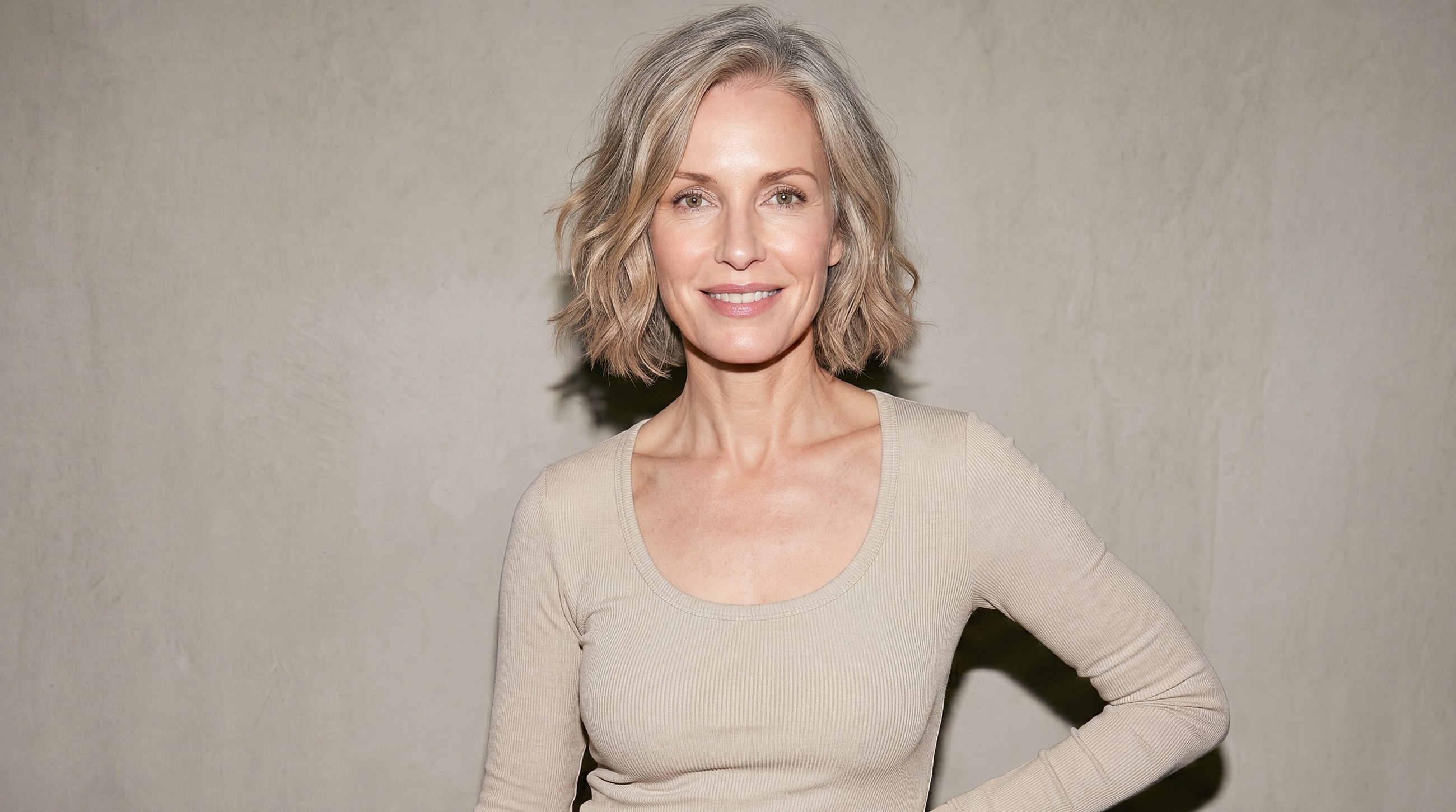 Smiling woman with short, wavy gray hair.