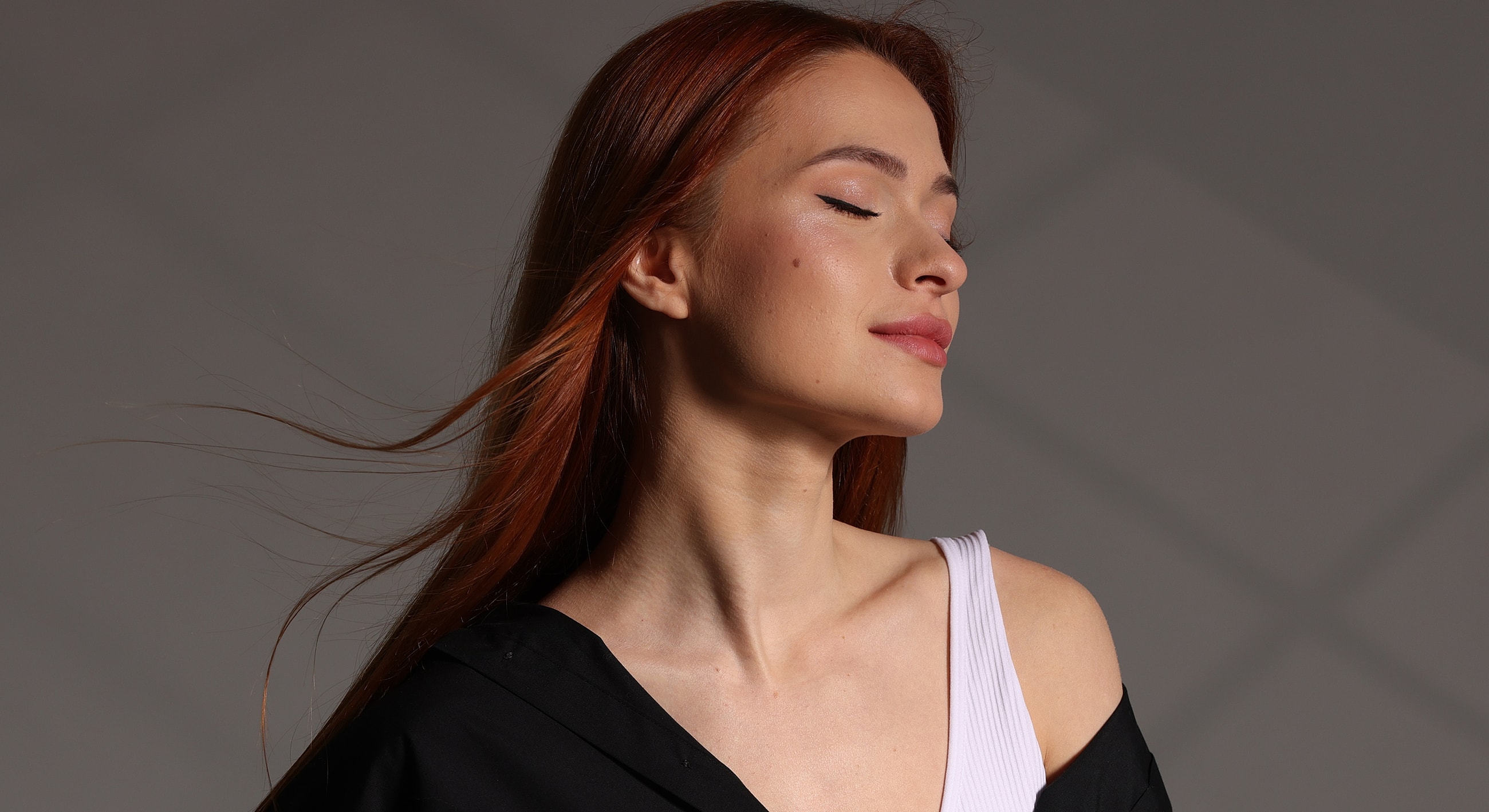 Woman with flowing hair and serene expression.