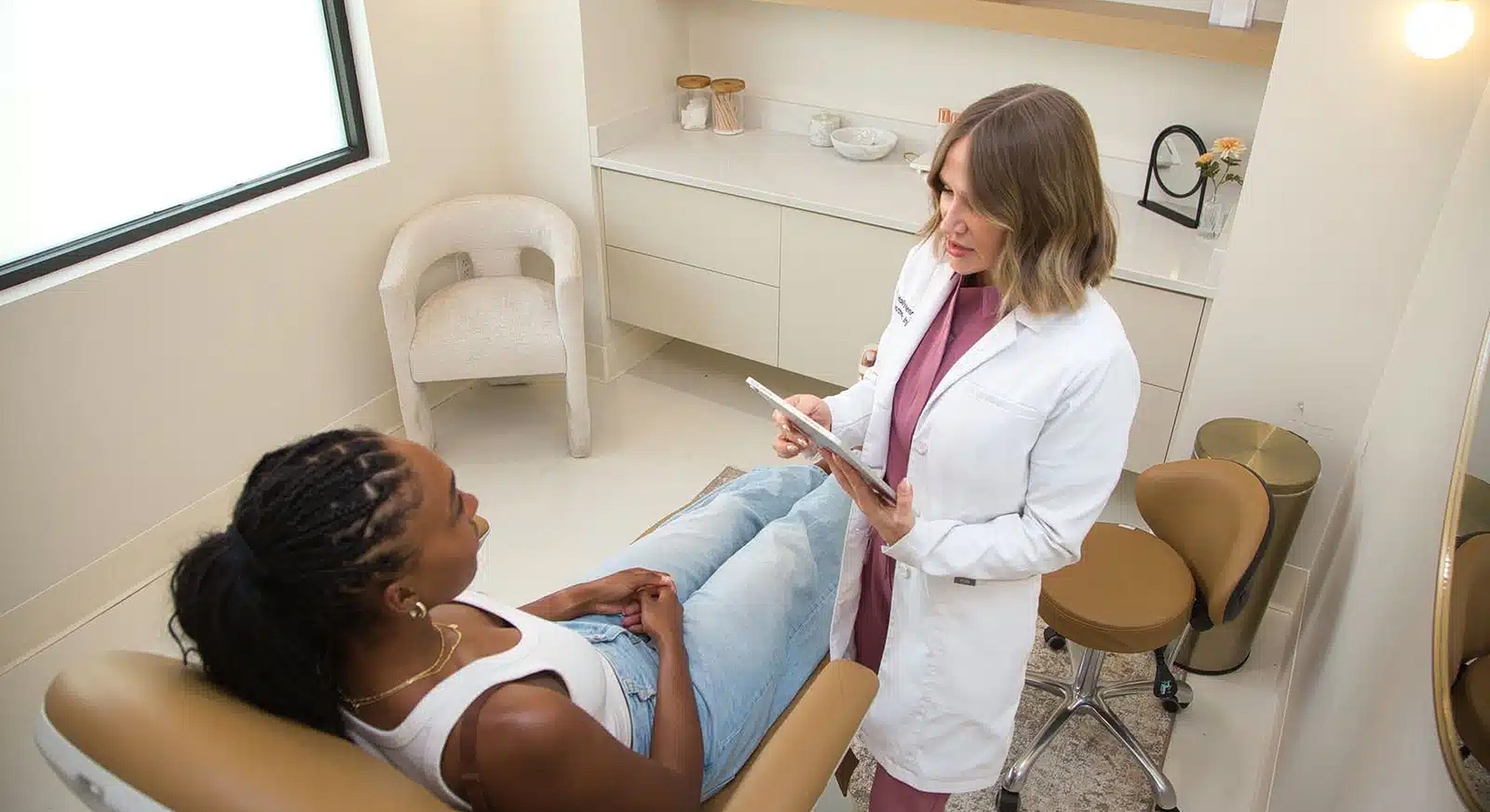 Doctor consulting patient in a clinical setting.